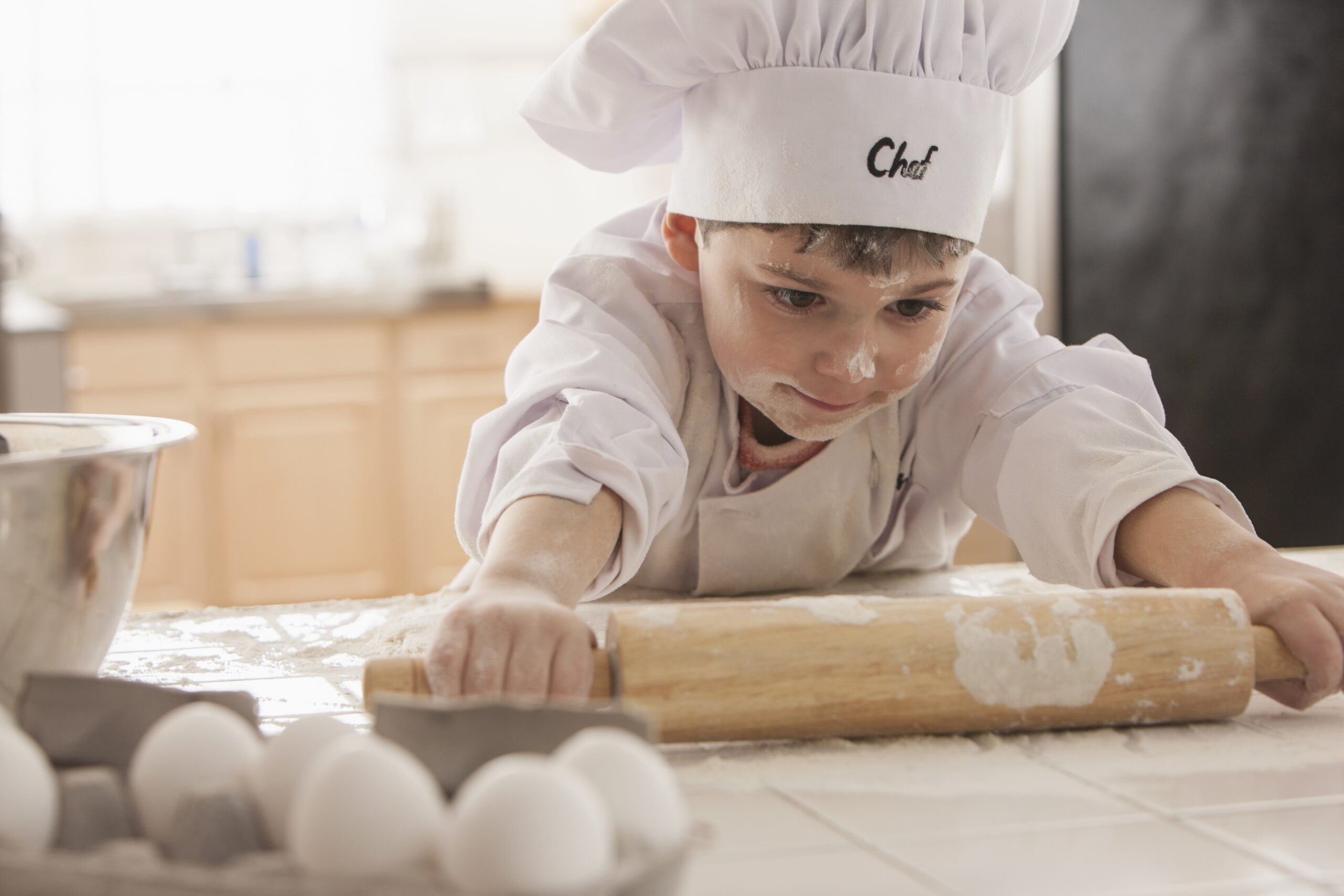 Boy baking in chef's whites
