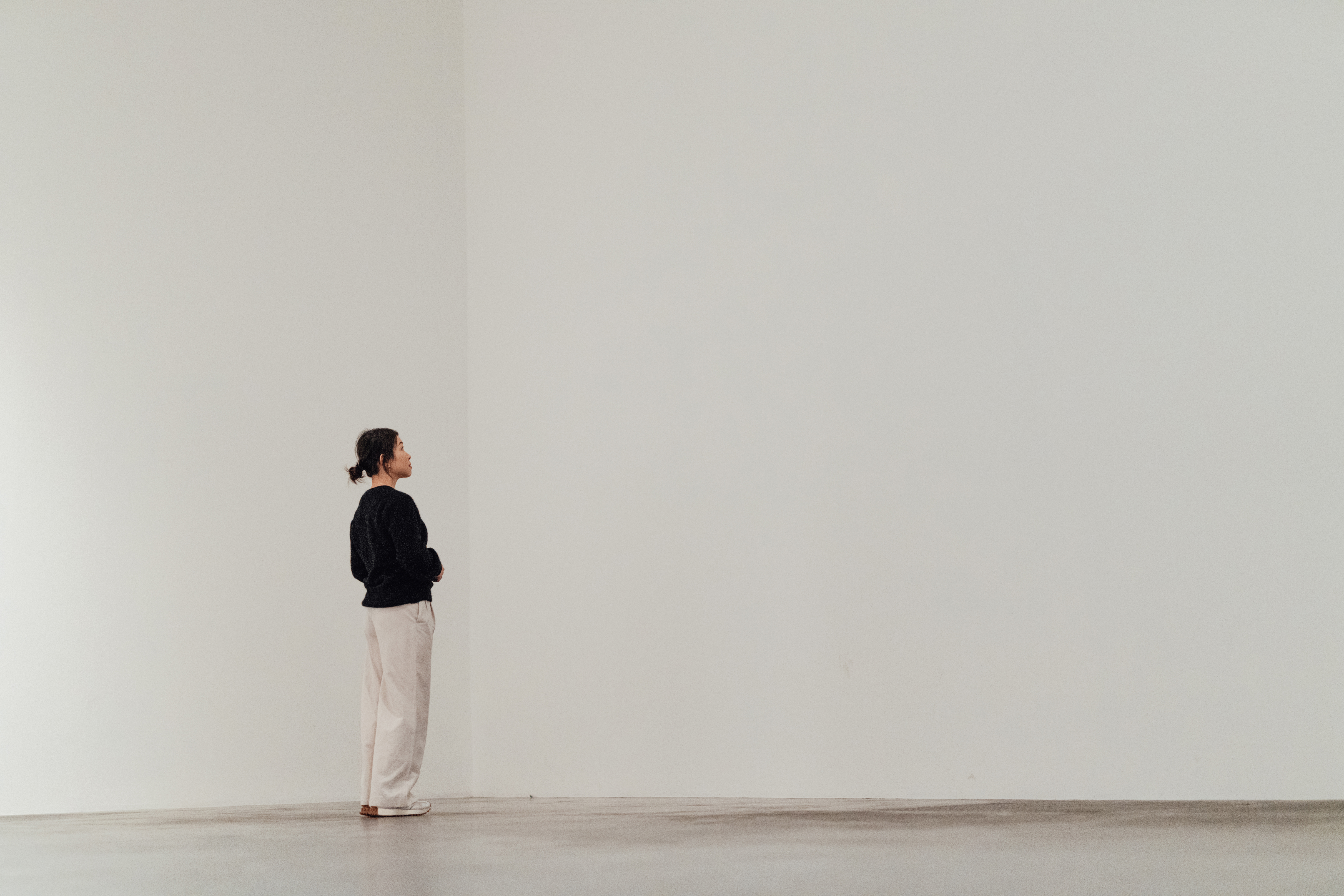 Mockup of a woman looking at painting/ photography in a contemporary art gallery. Art and culture. Art therapy.